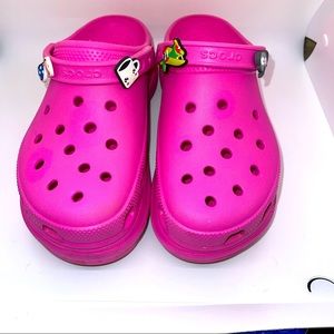Pink platform crocs.